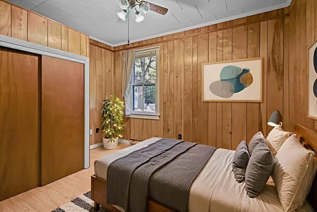 a bedroom with a bed and a window