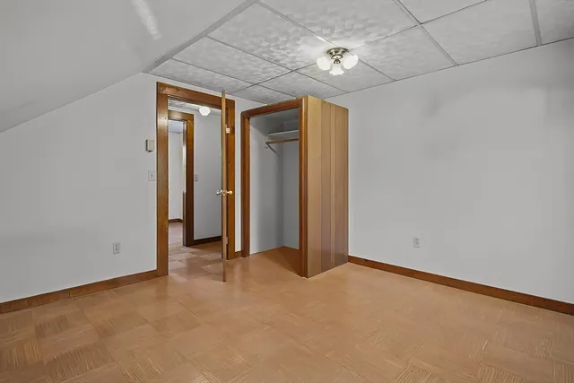 an empty room with chandelier fan