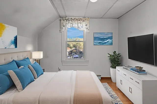 a bedroom with a bed and a flat screen tv