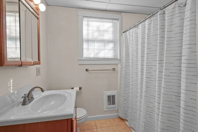 a bathroom with a sink a toilet and mirror