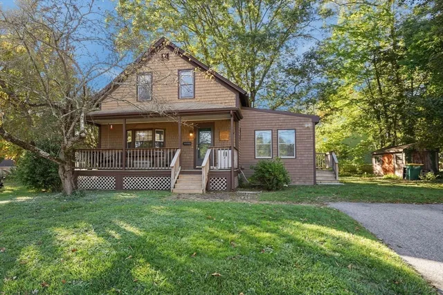 a front view of a house with yard and green space