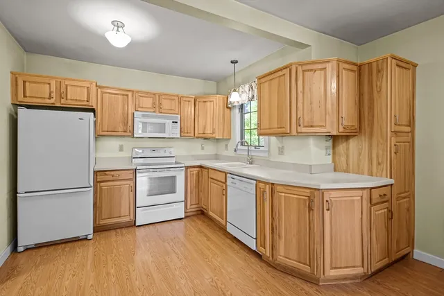 a kitchen with stainless steel appliances granite countertop a refrigerator sink and cabinets