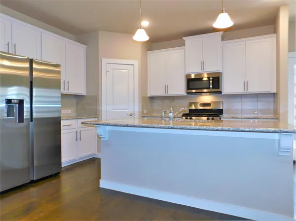 an empty room with a bathroom and a sink