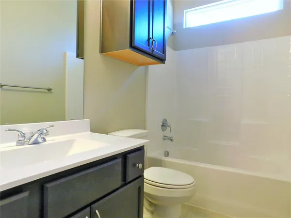 an empty room with windows and fireplace