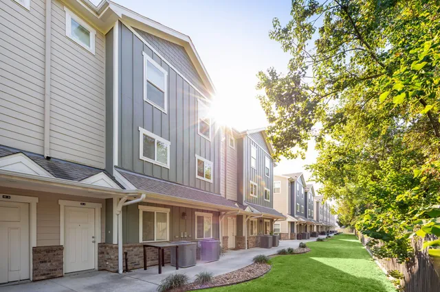 a front view of a residential apartment building with a yard