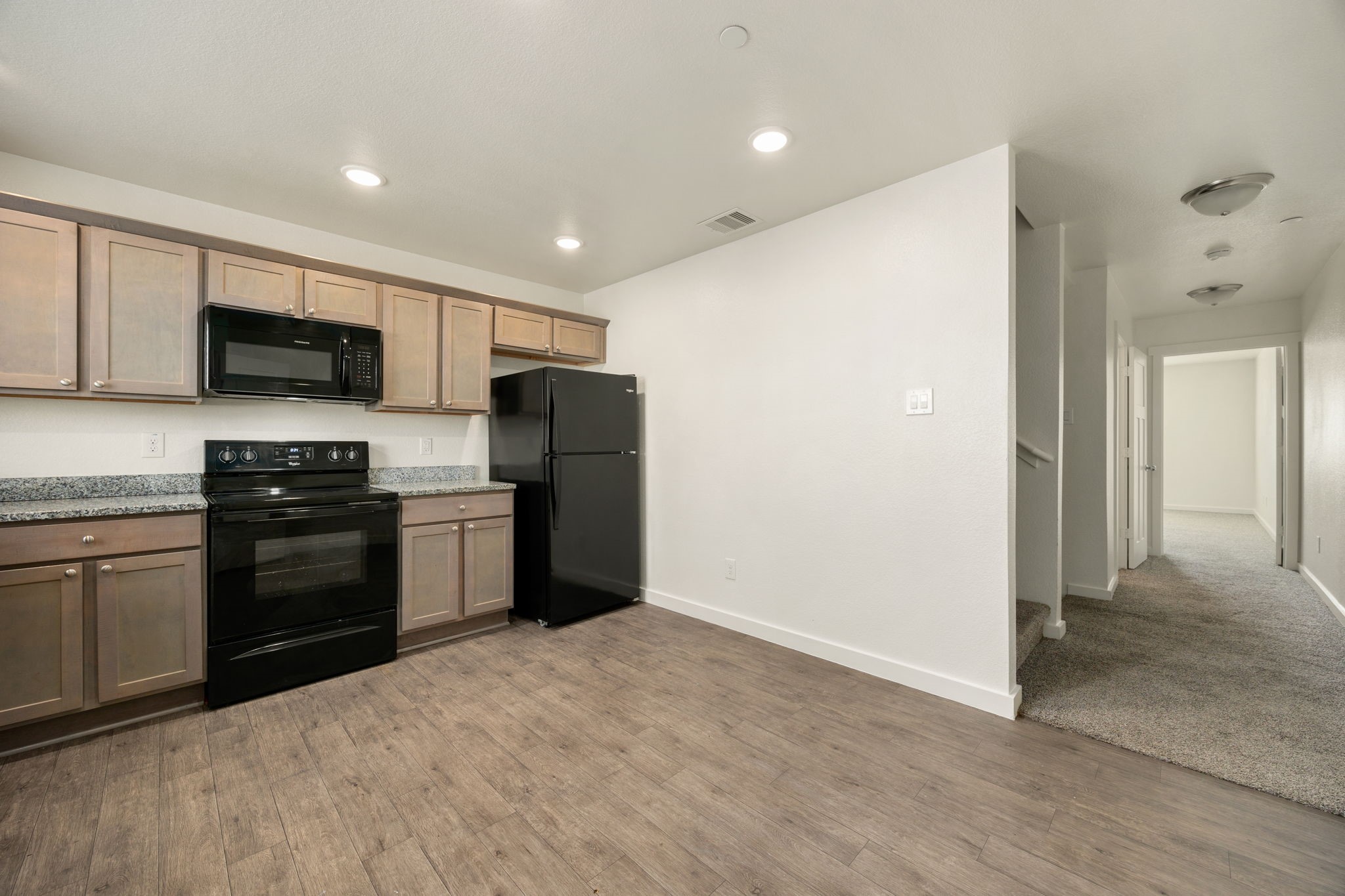 21155 Gosling Road, Unit 30 Spring, TX 77388 - Photo 10 of 32 a kitchen with granite countertop a refrigerator and a stove top oven