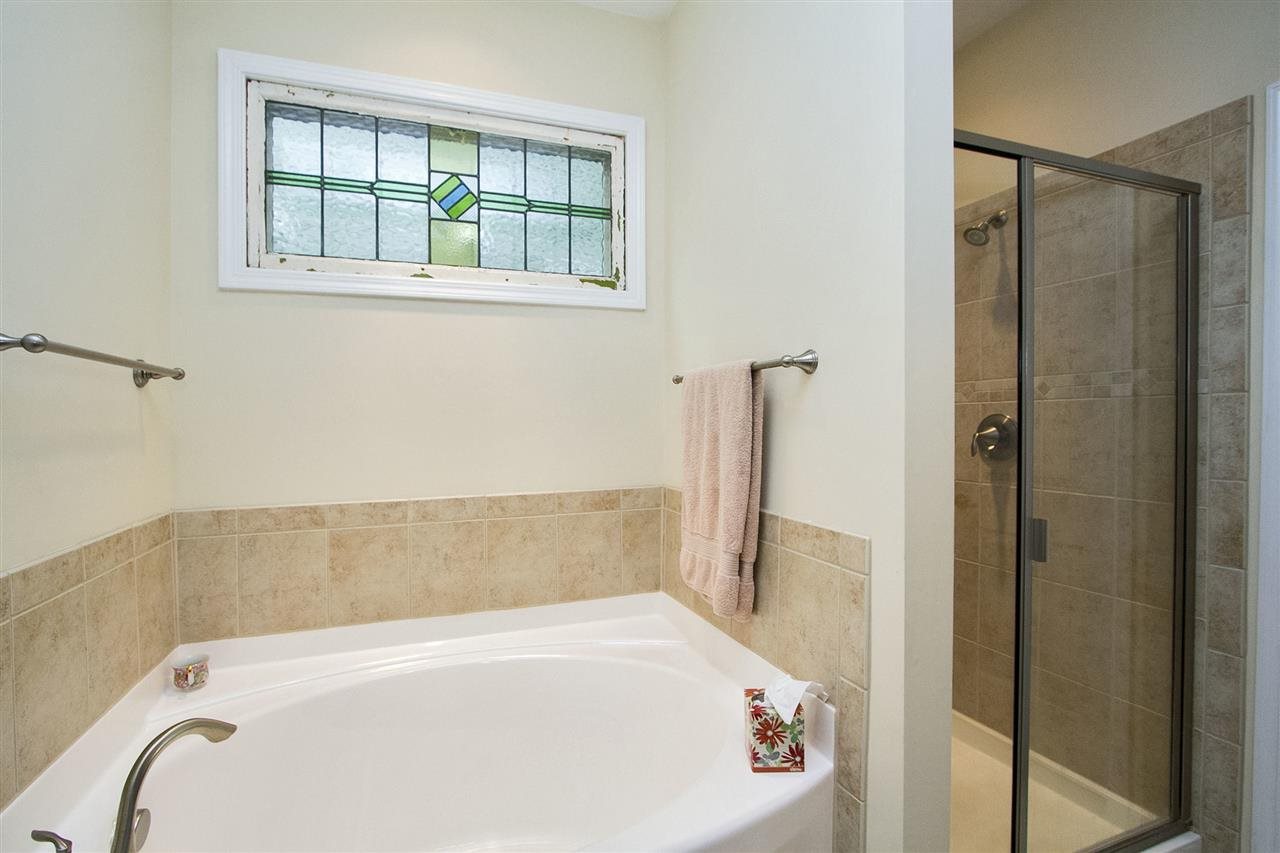 5520 Wade Park Boulevard Raleigh, NC 27607 - Photo 14 of 22 a bathroom with a tub and a shower