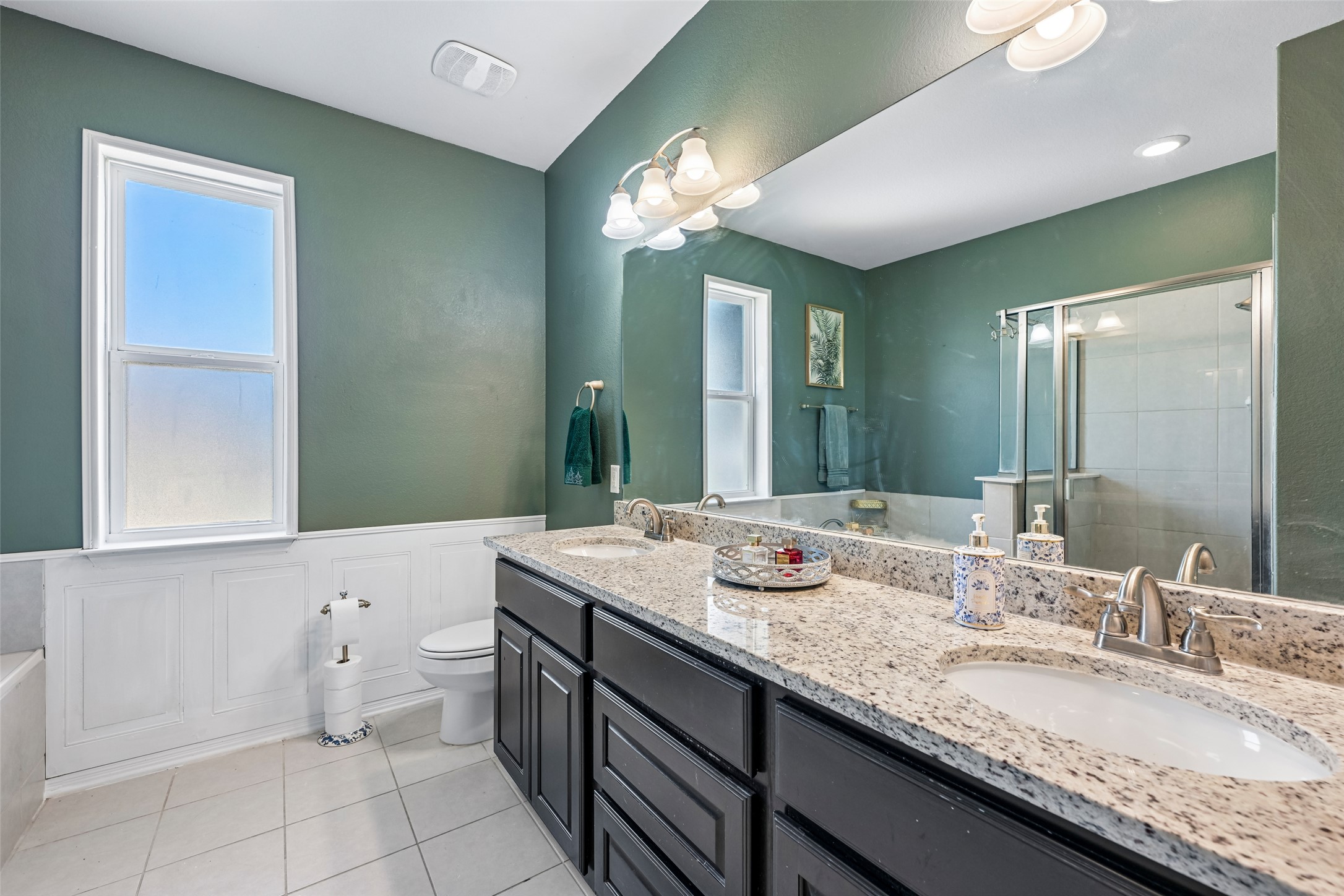 1297 Harwell Loop Kyle, TX 78640 - Photo 21 of 39 A well-appointed primary bathroom featuring a double vanity with granite counters and tiled flooring.