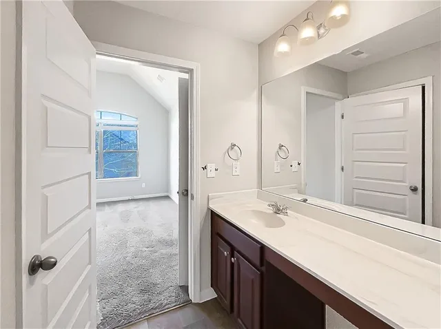 a bathroom with a sink double vanity and a mirror