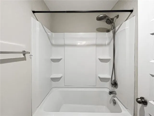 a bathroom with a shower and a bathtub