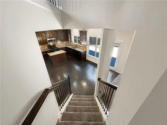 a kitchen with kitchen island granite countertop wooden cabinets and a stainless steel appliances