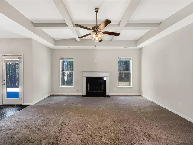 a view of an empty room with a fireplace