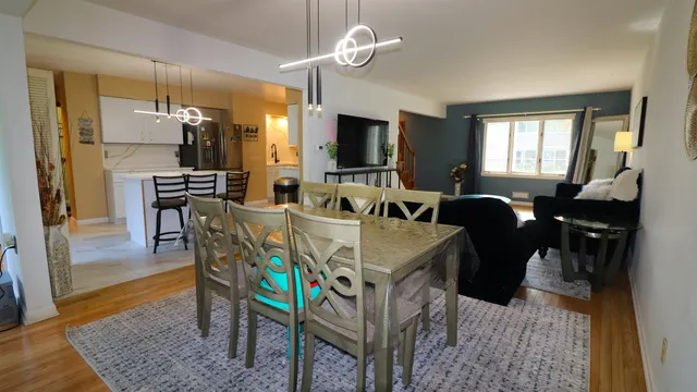 a view of a a dining room with furniture window and wooden floor