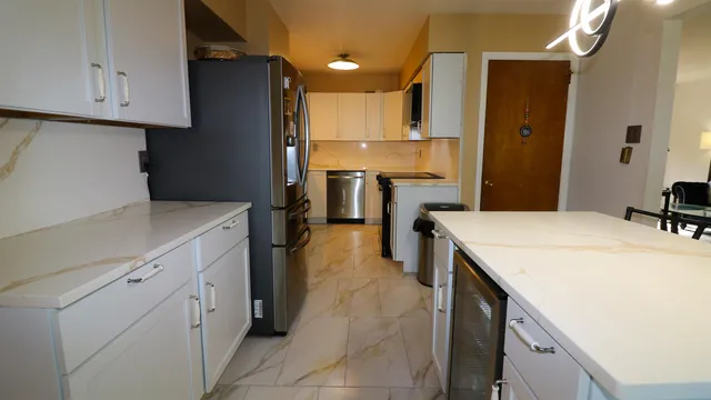 a kitchen with a refrigerator a sink and wooden cabinets