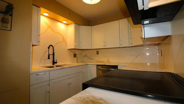 a kitchen with a sink and cabinets