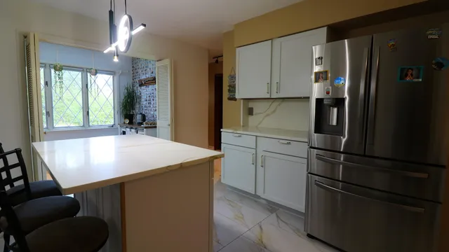 a kitchen with stainless steel appliances granite countertop a refrigerator and a sink