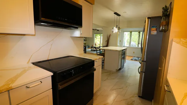 a kitchen with a stove and a refrigerator