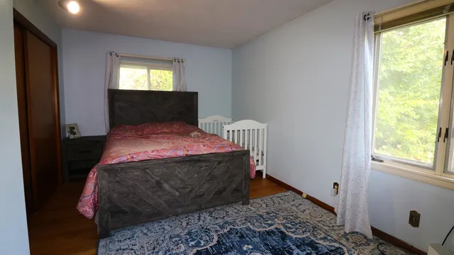 a bedroom with a bed and window