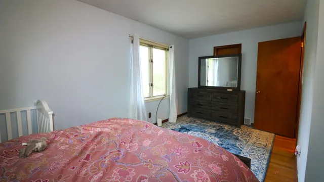 a bedroom with a bed and a dresser