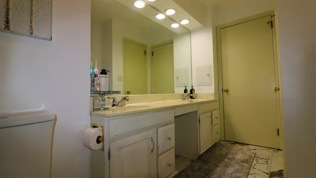 a bathroom with a double vanity sink and mirror