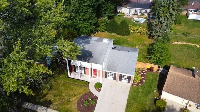 an aerial view of residential house with outdoor space and swimming pool