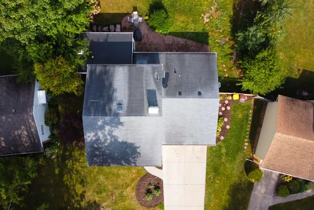 an aerial view of a house with a yard