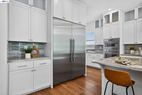 a kitchen with cabinets stainless steel appliances and a counter space