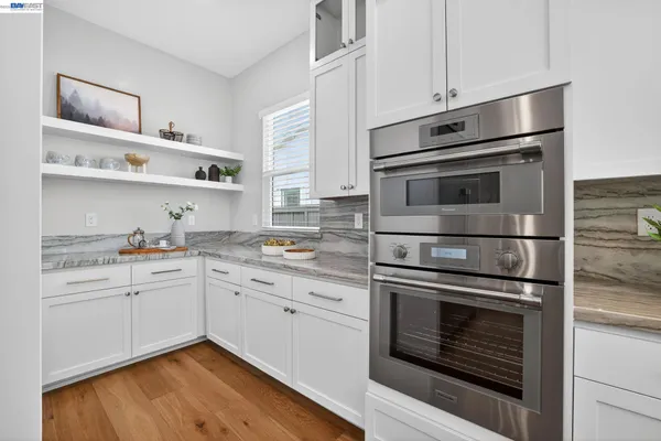 a kitchen with sink stove and cabinets