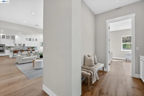 a bedroom with a large bed and wooden floor