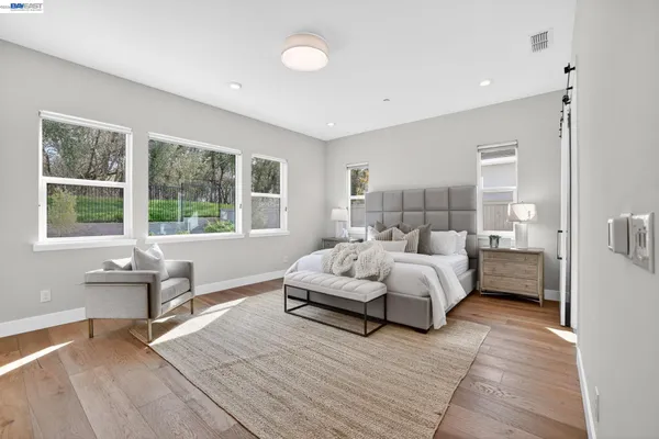 a bedroom with a bed and a large window