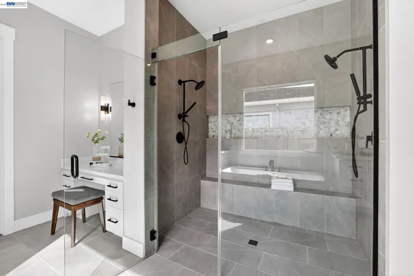a spacious bathroom with a shower sink and a mirror