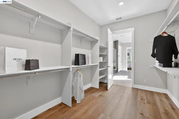 a dining room with furniture potted plants and wooden floor
