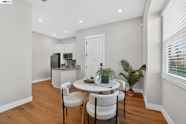 a work room with furniture wooden floor and a flat screen tv