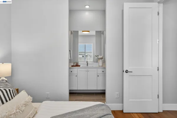 a view of a house with lounge chair and dinning table under an umbrella
