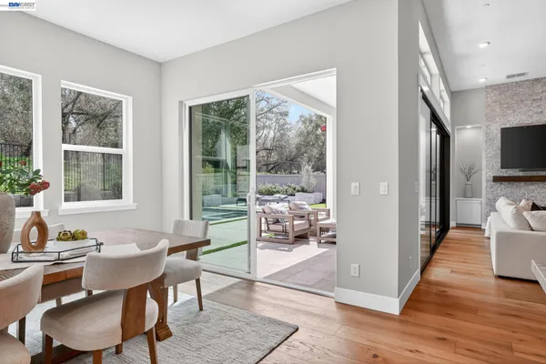 a view of a chairs and table in the backyard
