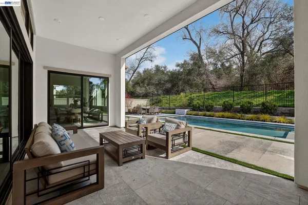 a view of a house with swimming pool and sitting area