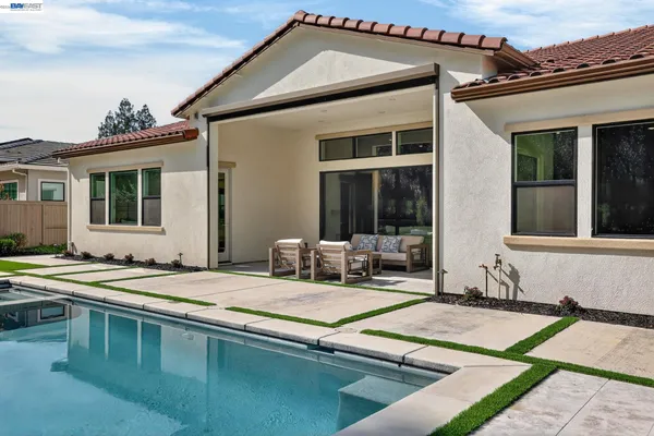 an aerial view of multiple houses with a yard