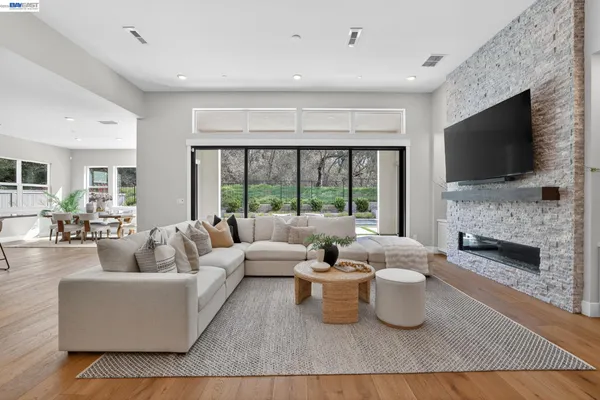 a living room with furniture and kitchen view