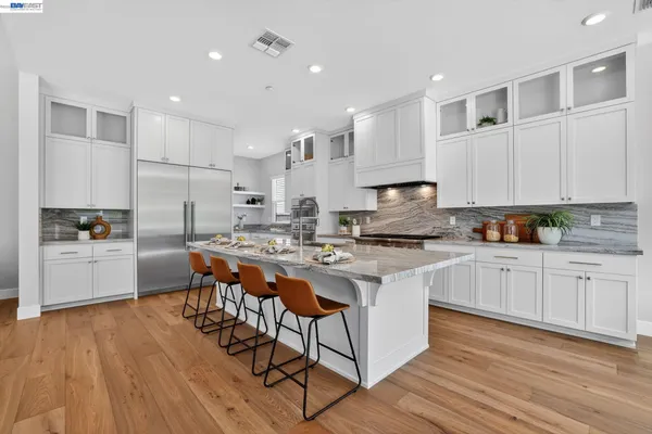 a kitchen with stainless steel appliances granite countertop a refrigerator sink and cabinets
