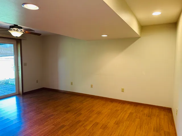 a view of an empty room with wooden floor