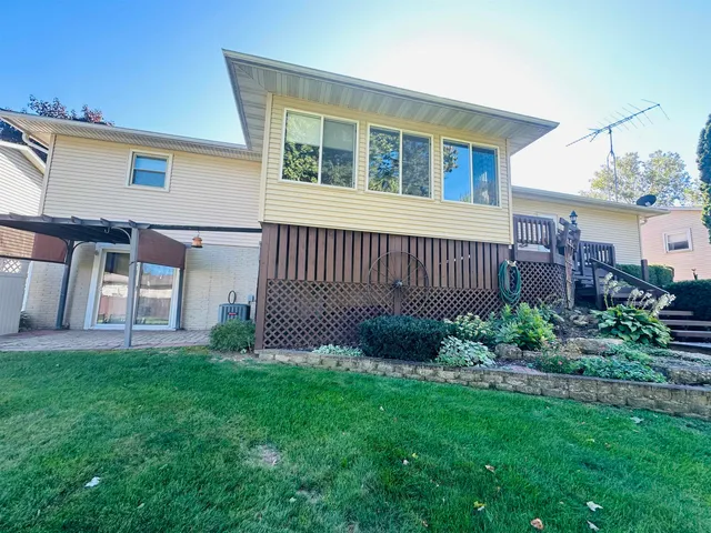 a view of a house with a yard and porch