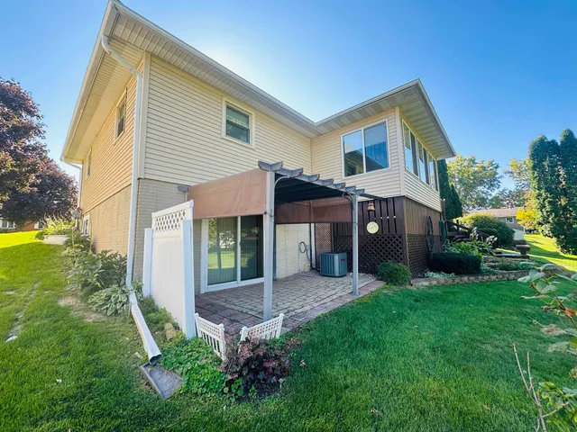 a front view of a house with a garden and plants