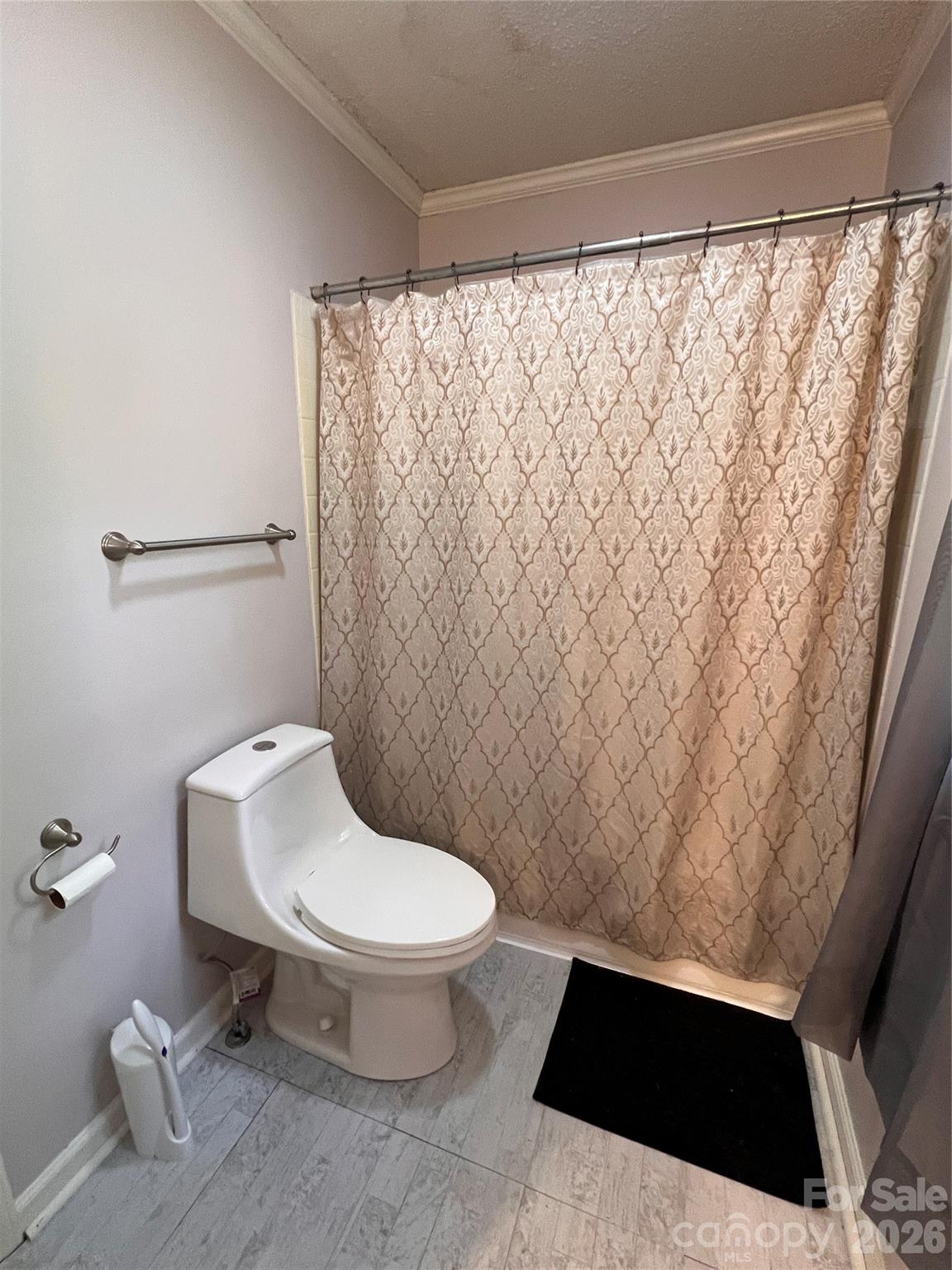 1426 Alf Hoover Road Vale, NC 28168 - Photo 16 of 35 a white toilet sitting next to a shower curtain