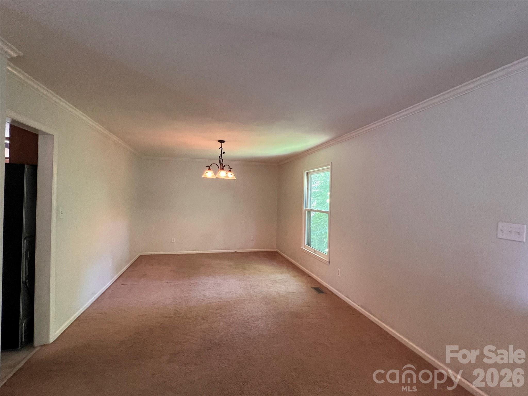 1426 Alf Hoover Road Vale, NC 28168 - Photo 4 of 35 an empty room with windows and chandelier fan