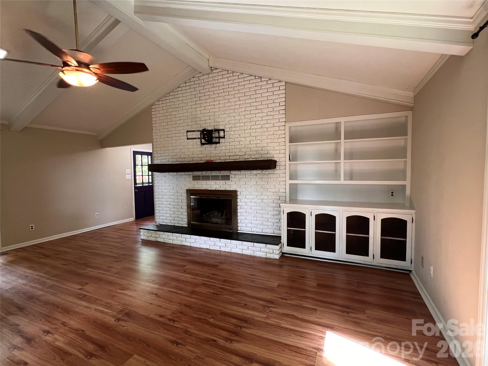 1426 Alf Hoover Road Vale, NC 28168 - Photo 7 of 35 a view of an empty room with wooden floor fireplace and a window