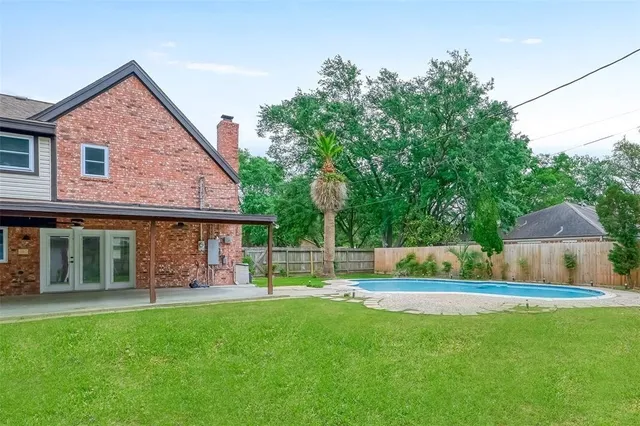 a front view of a house with a yard and trees