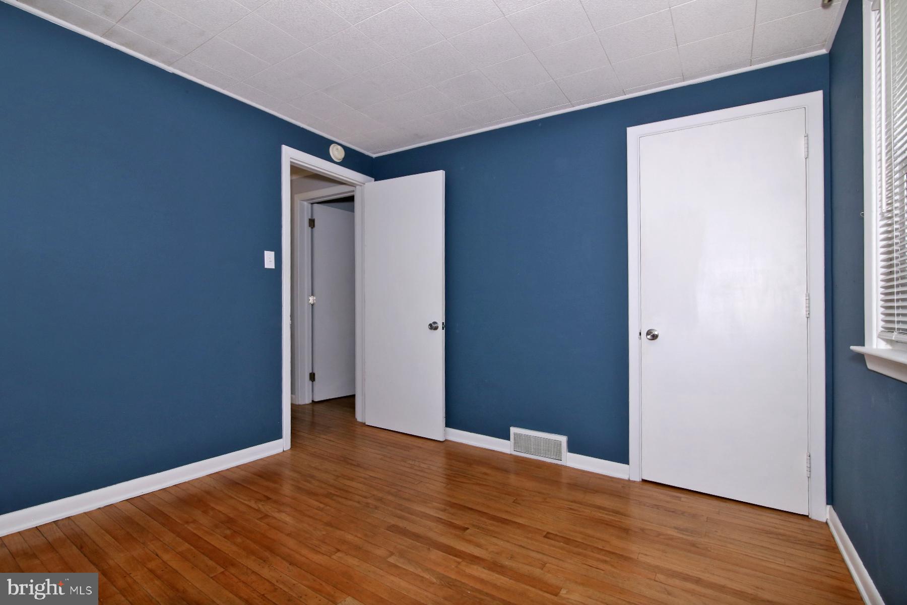 1217 Broadway Boulevard Reading, PA 19607 - Photo 15 of 35 a view of an empty room with wooden floor and a window