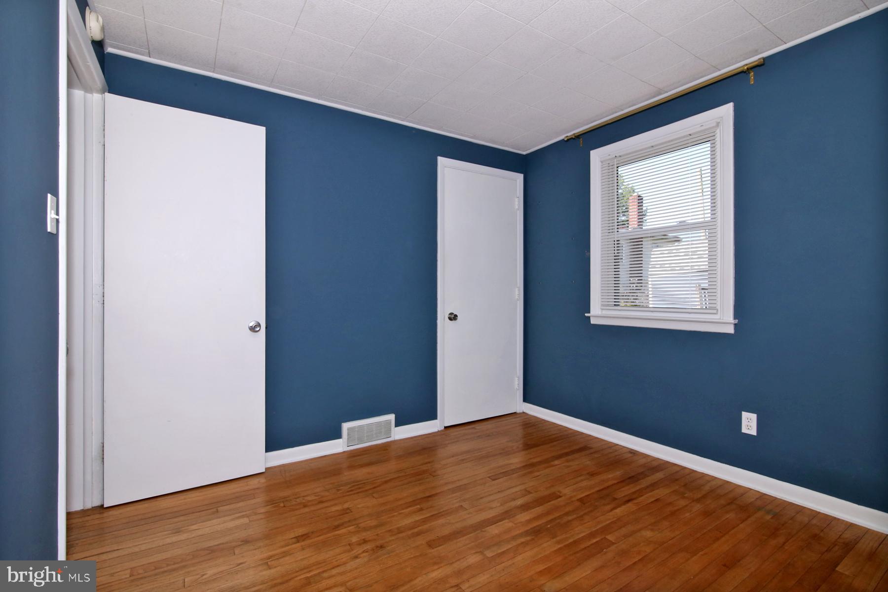 1217 Broadway Boulevard Reading, PA 19607 - Photo 16 of 35 a view of an empty room with wooden floor and a window