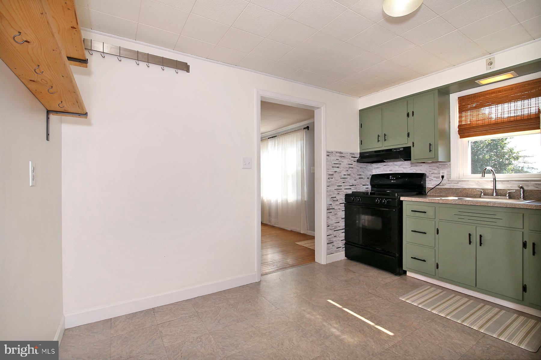 1217 Broadway Boulevard Reading, PA 19607 - Photo 4 of 35 a kitchen with a refrigerator and a stove
