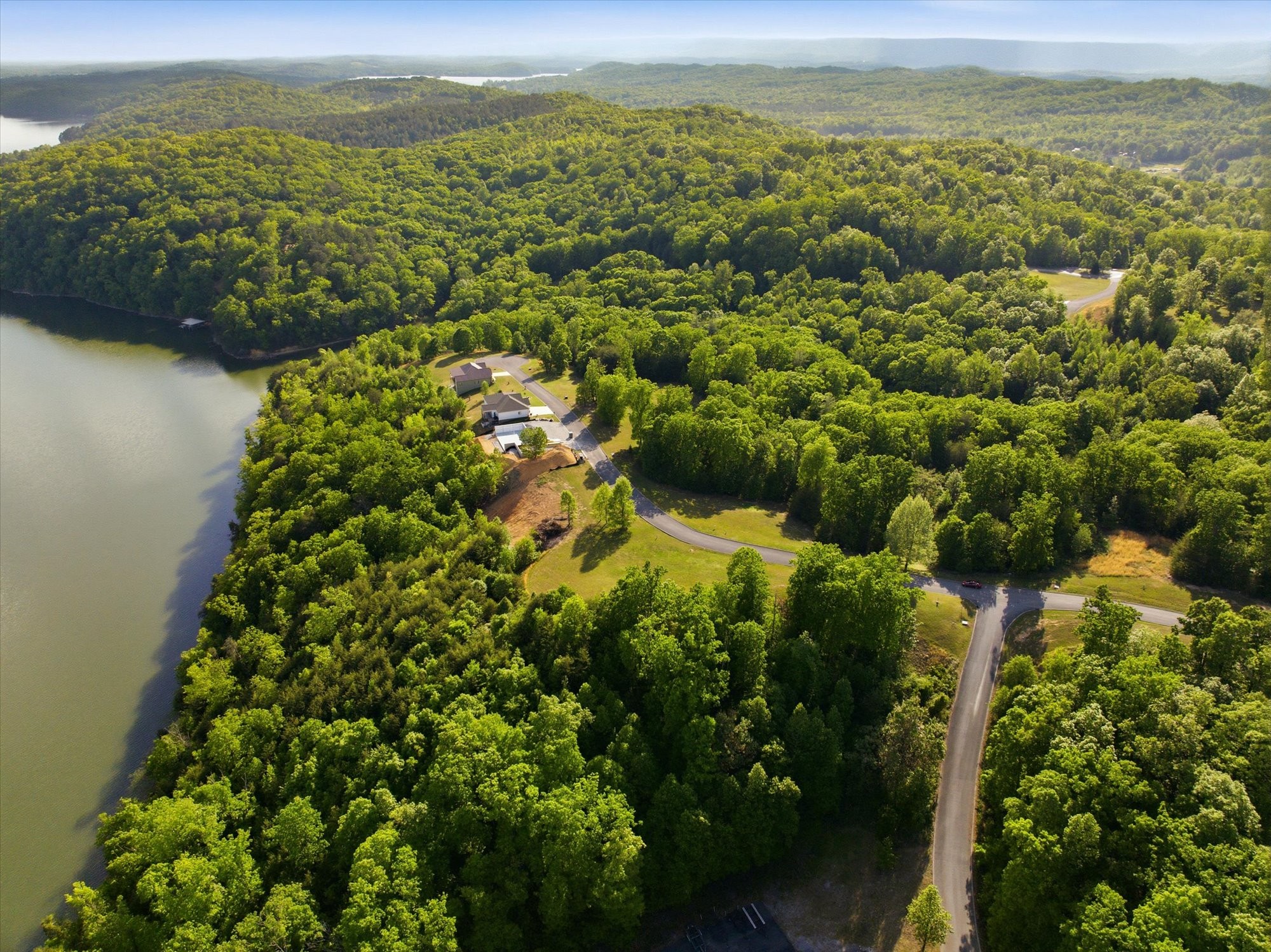 240 River Run Trail Spring City, TN 37381 - Photo 19 of 24 a view of a lake with a mountain in the background